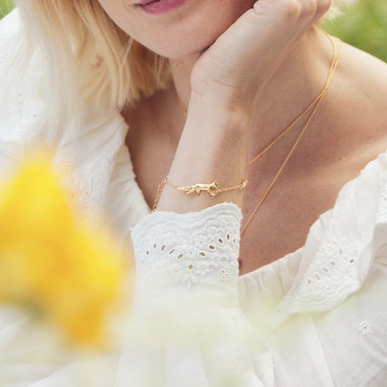 close up of a model wearing the fox, rabbit, mouse chase bracelet
