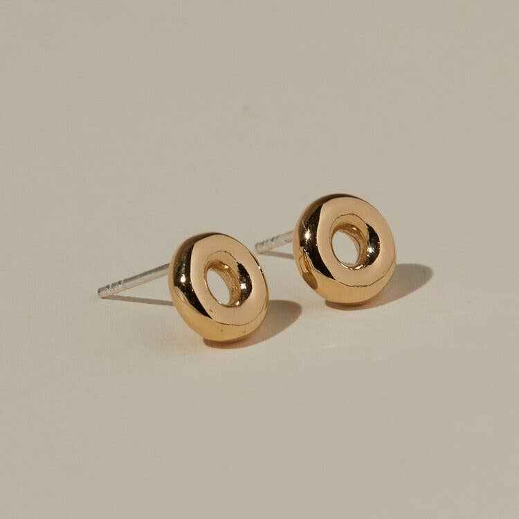 angled view of the mia studs on a beige background