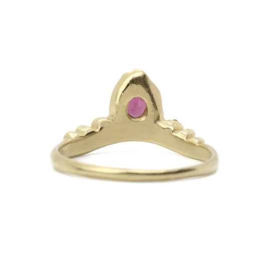 Back of gold, pear cut diamond ring pictured on white background