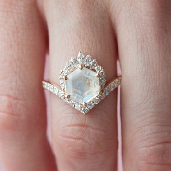 Close up view of the moonstone devoir ring modeled on a hand.