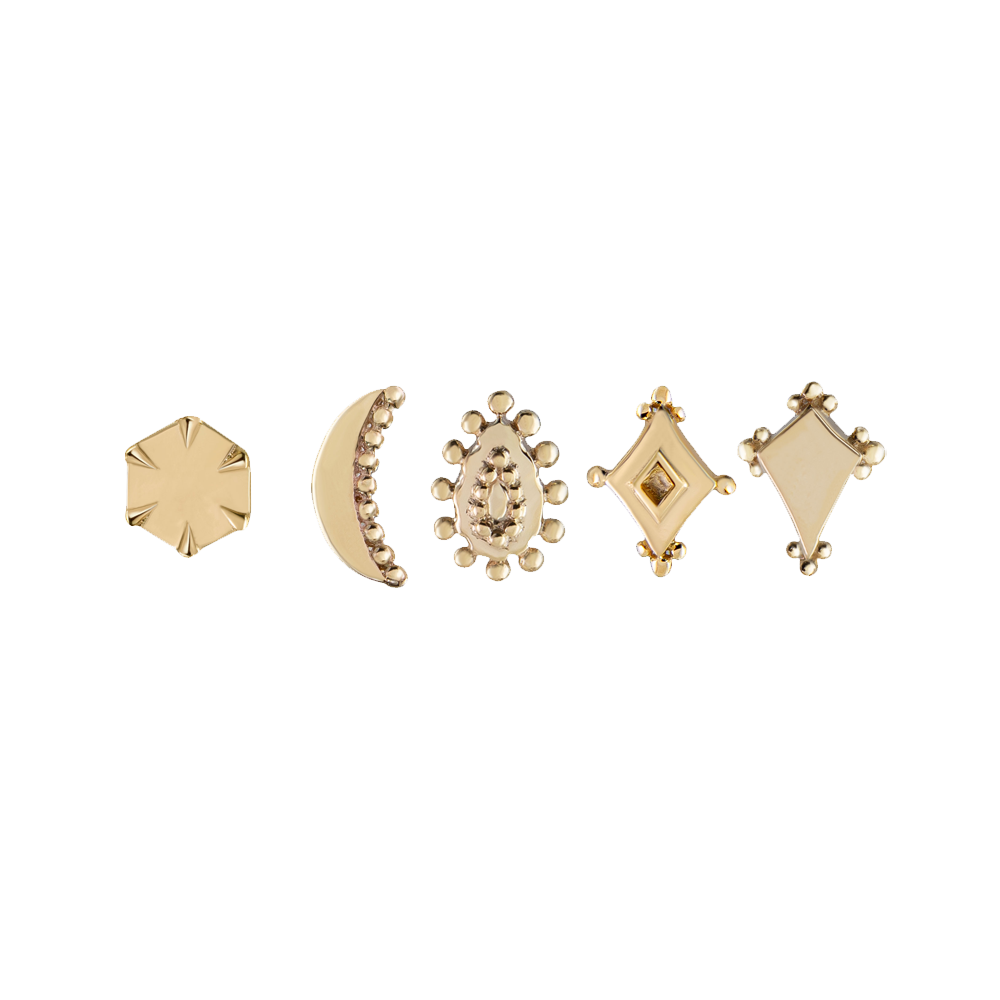 five gold studs in varying shapes on a white background