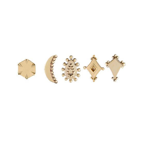 five gold studs in varying shapes on a white background