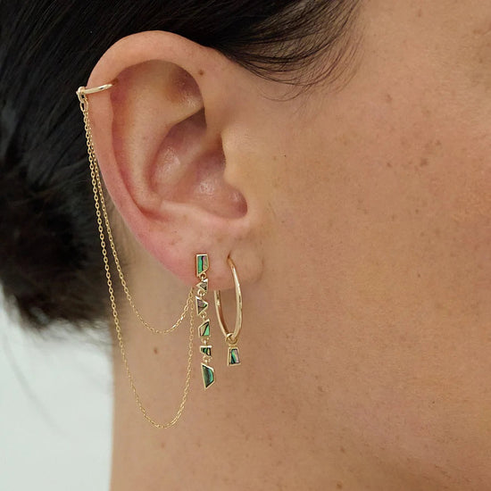 Load image into Gallery viewer, close up of a model wearing the large gold hoop with abalone charm along with two gold earrings with abolone and chain details
