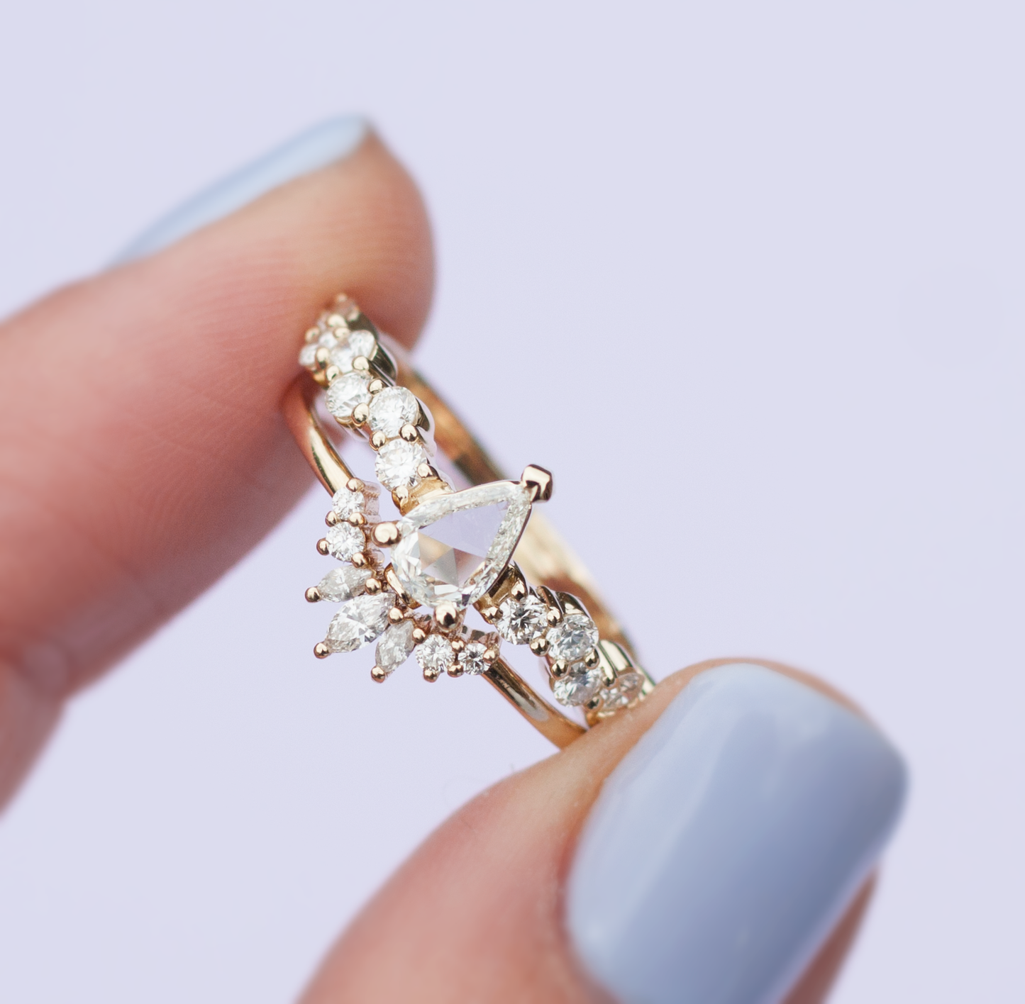 Load image into Gallery viewer, Hand holding the white diamond intertwine ring stacked with a white diamond crown band, close up.
