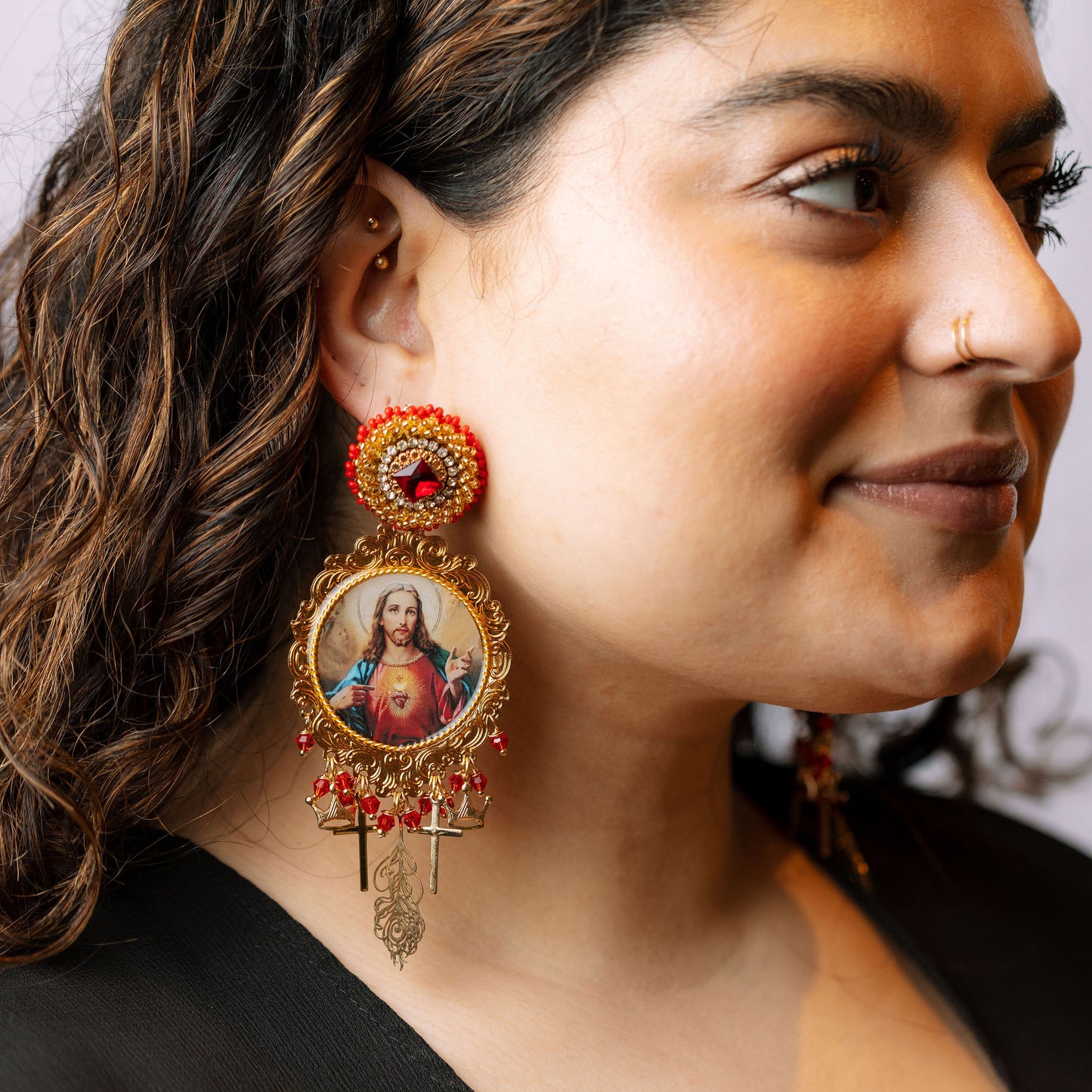 Jesus earrings on model