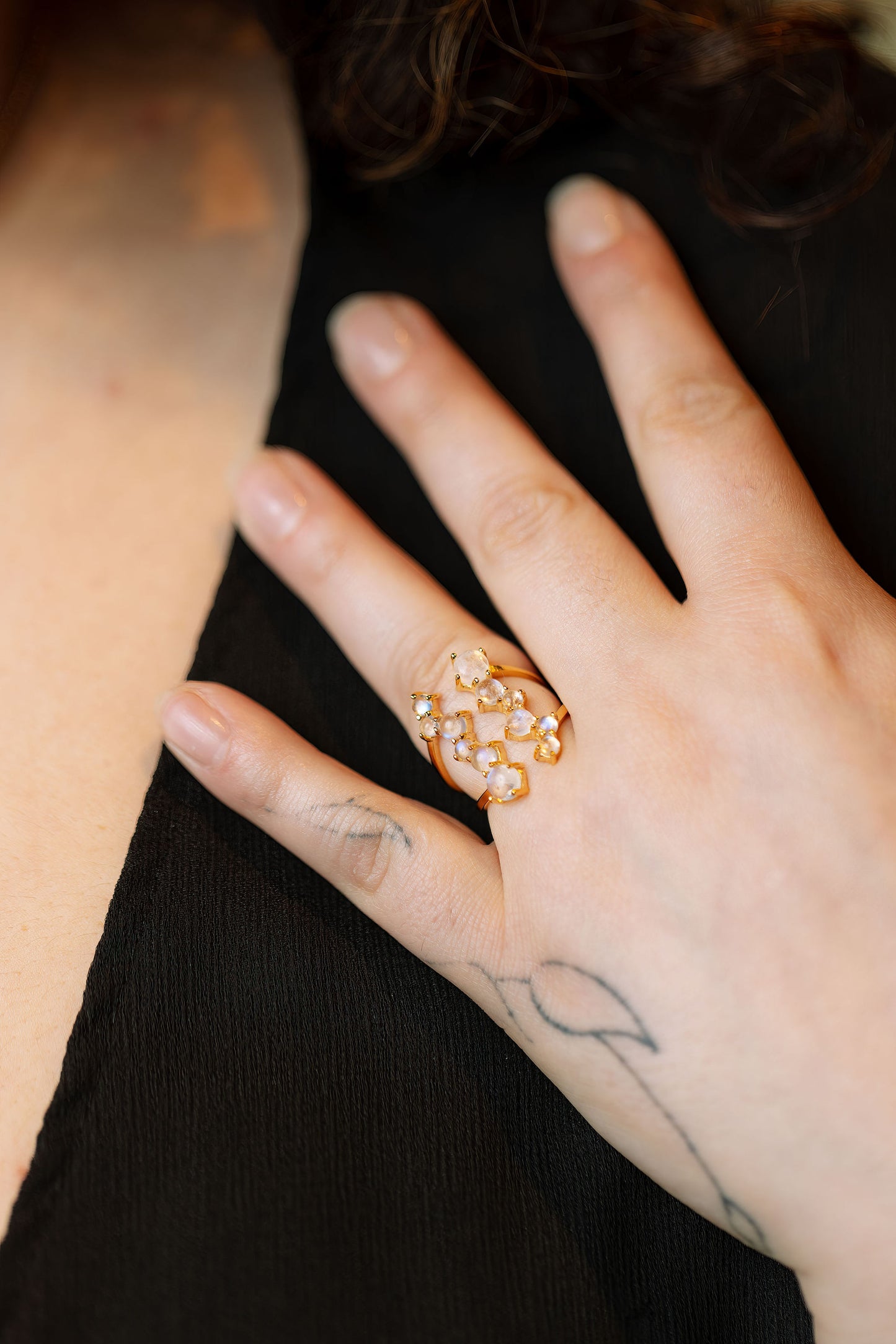 close up of a model wearing the via lactea ring in gold