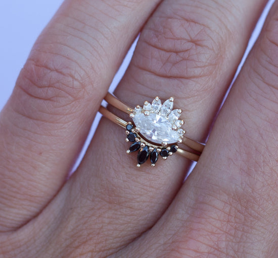 White diamond sideways set marquise ring with diamond crown, stacked on hand with black diamond crown.