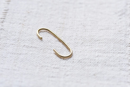 the linea cuff earring on light taupe linen background