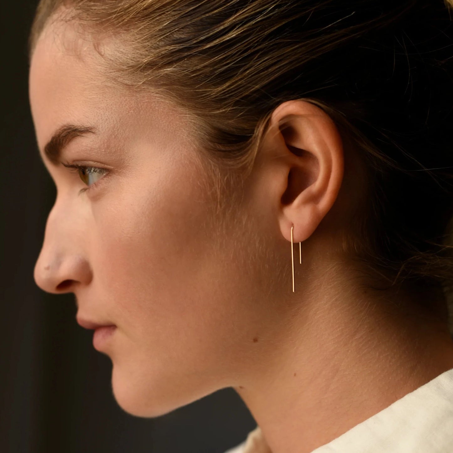 Load image into Gallery viewer, model wearing the gold asymmetrical arch threader earrings
