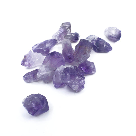 Load image into Gallery viewer, Pile of amethyst quartz on white bakground.
