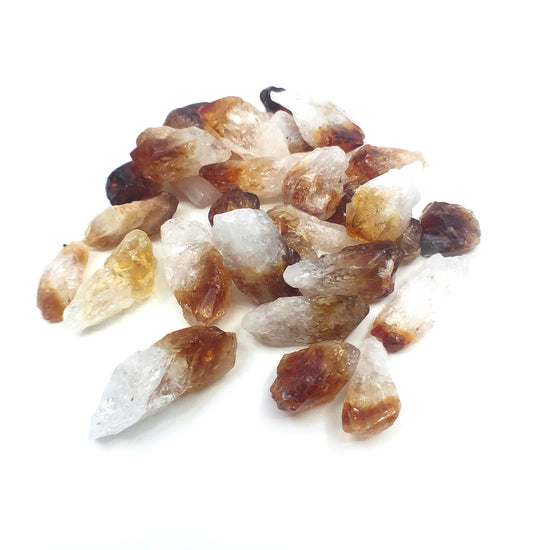 Load image into Gallery viewer, Pile of citrine quartz on white background.
