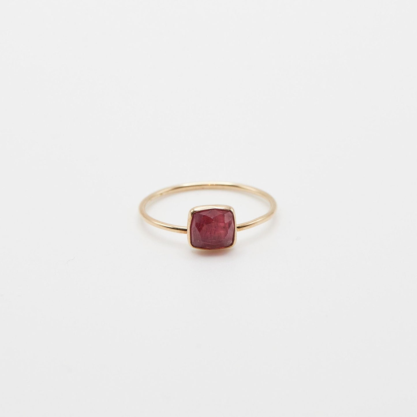 small pink square tourmaline stone bezel set in 14k yellow gold ring on white background