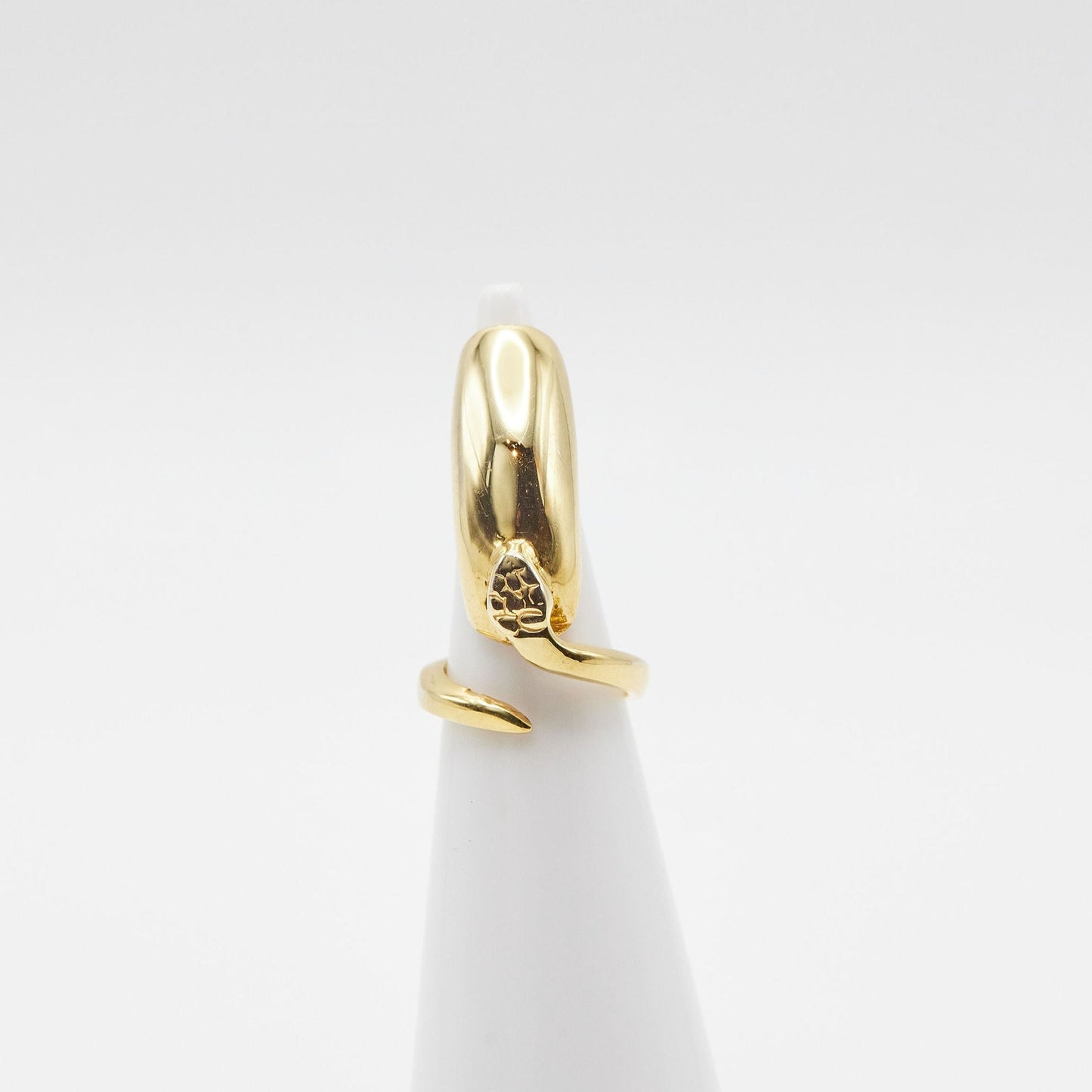 Load image into Gallery viewer, gold nail ring with north facing snake details on ring cone with white background
