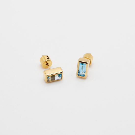 angled view of the rectangle gemstone stud earrings on white background