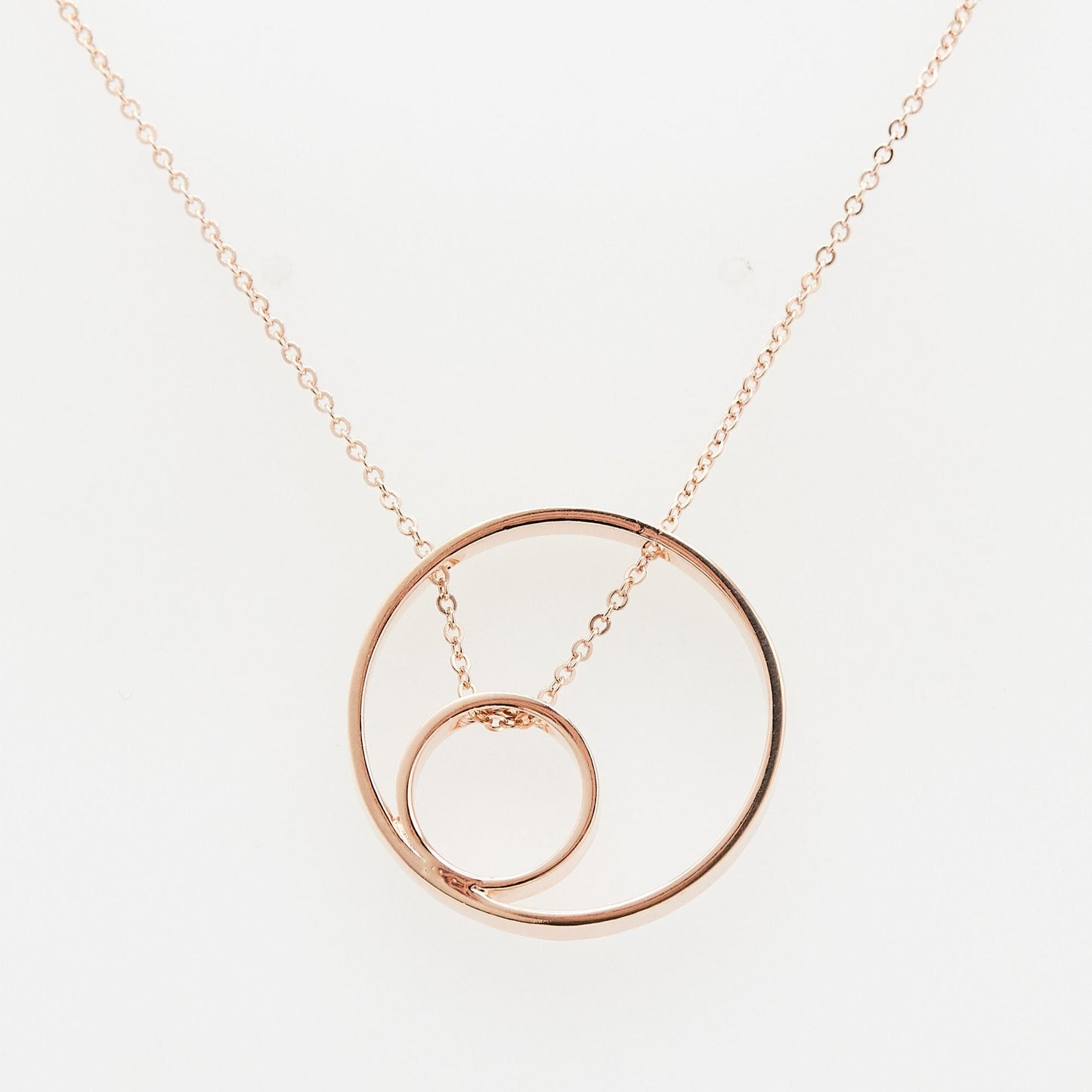 Load image into Gallery viewer, rose gold open circle pendant with small inner circle and chain threaded through on white background
