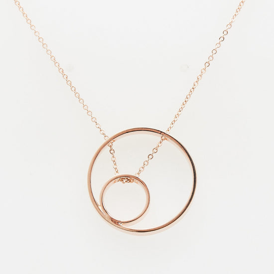 Load image into Gallery viewer, rose gold open circle pendant with small inner circle and chain threaded through on white background
