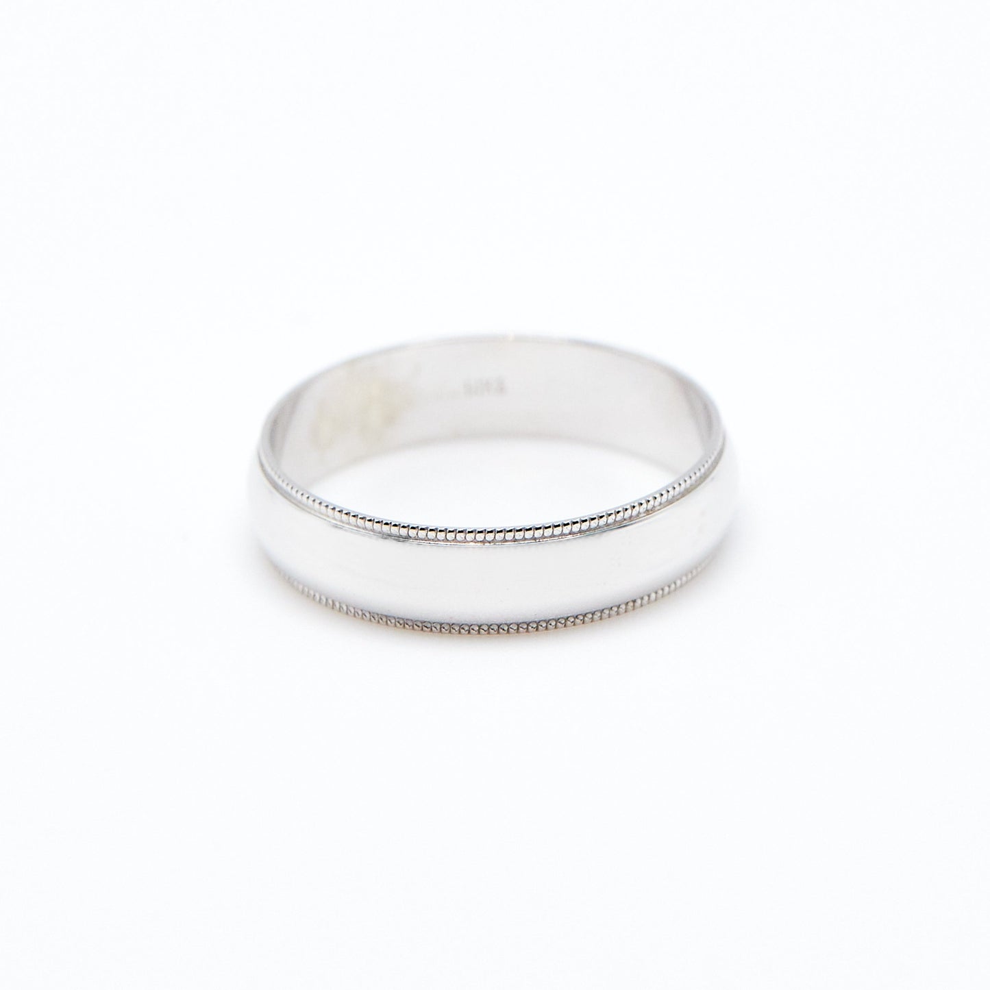 white gold 5mm half round wedding band with milgrain details on white background