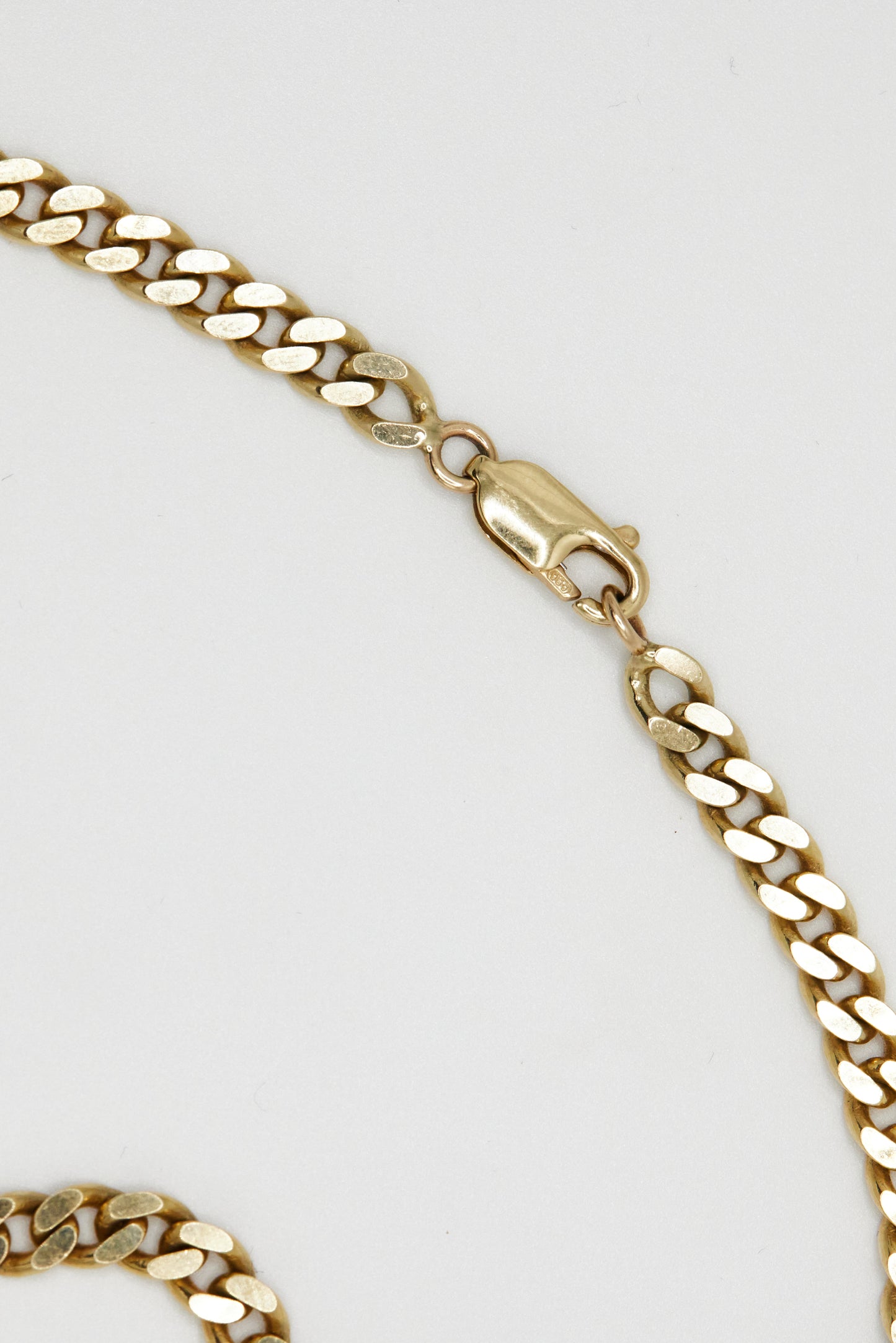 detail shot of the 14k yellow gold curb chain clasp