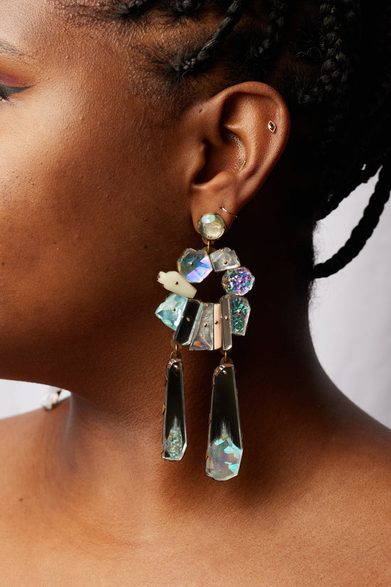 close up of model wearing the silver neogem drop earrings