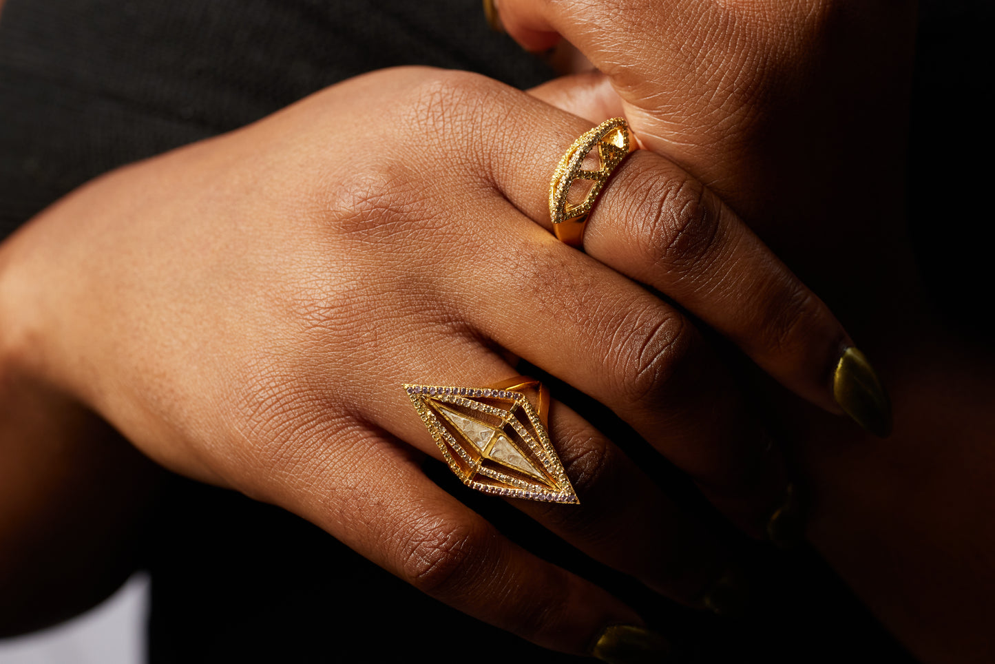 close up of model wearing the kontan ring on her ring finger and another shana gulati diamond ring on her ring finger