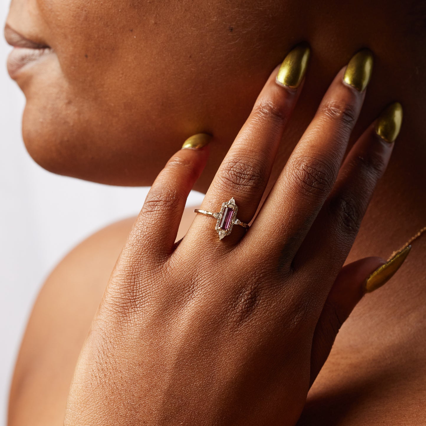close up of model wearing the maria baguette ring with her hand on her face