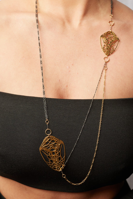 close up of the libra necklace on model