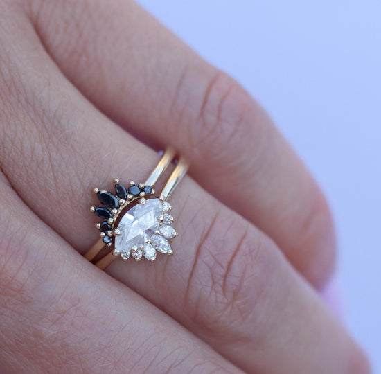 White diamond sideways set marquise ring with diamond crown, stacked on hand with black diamond crown.
