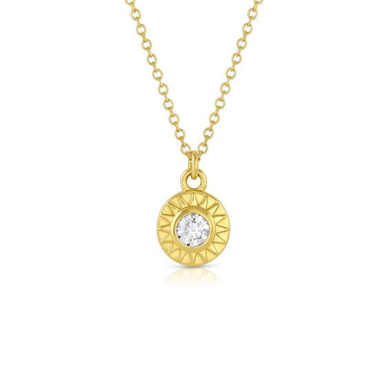 18k yellow gold sunburst circle pendant on a chain with diamond center stone.
