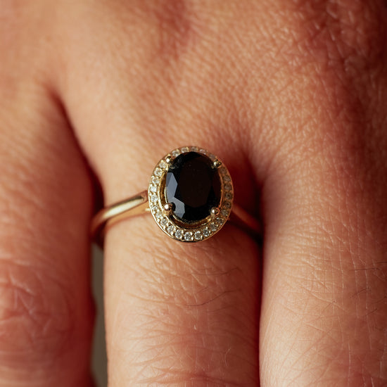 Load image into Gallery viewer, Madison Ave Ring with onyx center stone and diamond halo on hand.
