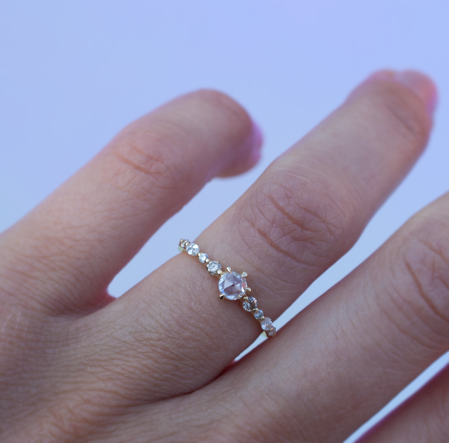 Rose cut diamond solitaire ring modeled on hand.