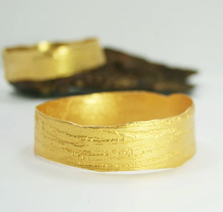 stylized shot of gold plated wide bangle