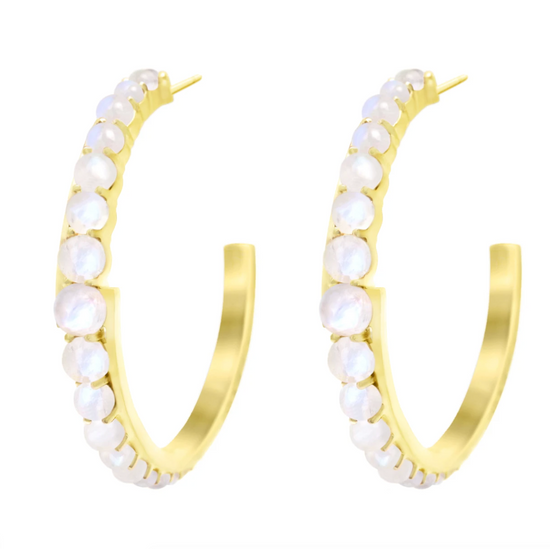 Rainbow moonstones set in a pair of yellow gold hoops on a white background