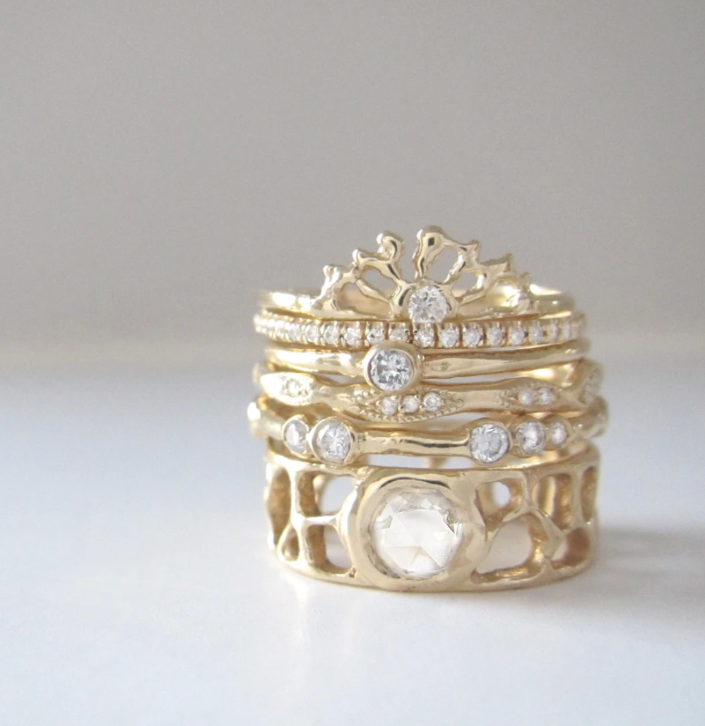 sunrise ring stacked with 6 gold and diamond bands.