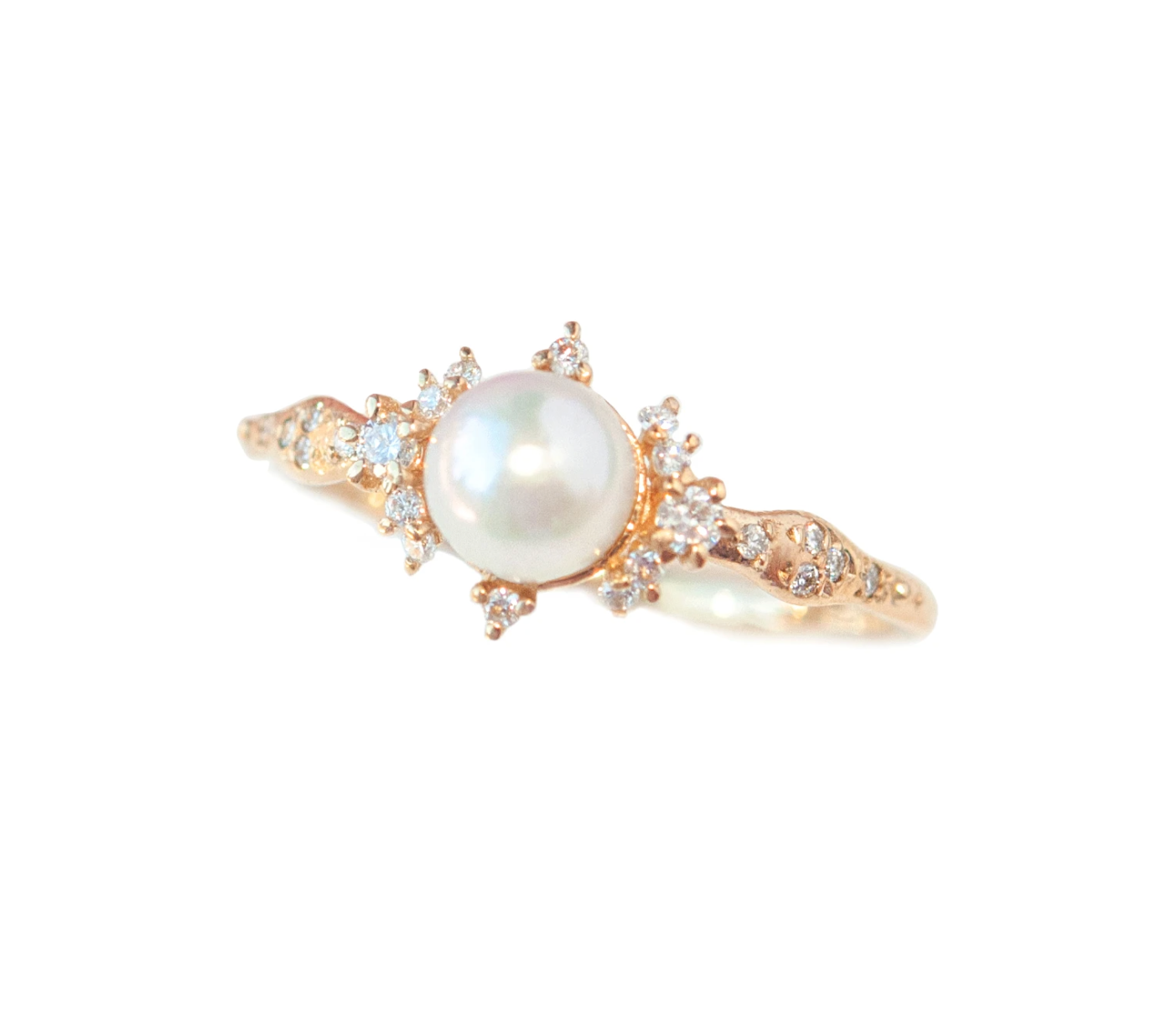 Pearl and diamond ring close up on white background.