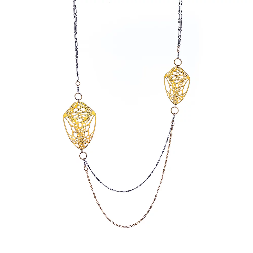 oxidized silver and a gold fill double chain necklace with two gold plated monarch butterfly inspired pendants on a white background