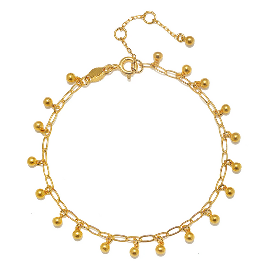 gold charm chain bracelet on white background.