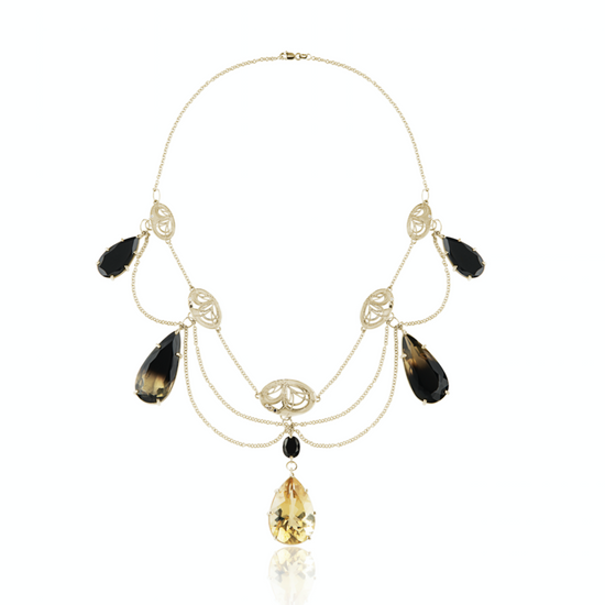 Citrine  and onyx gem necklace with yellow gold chain on white background 