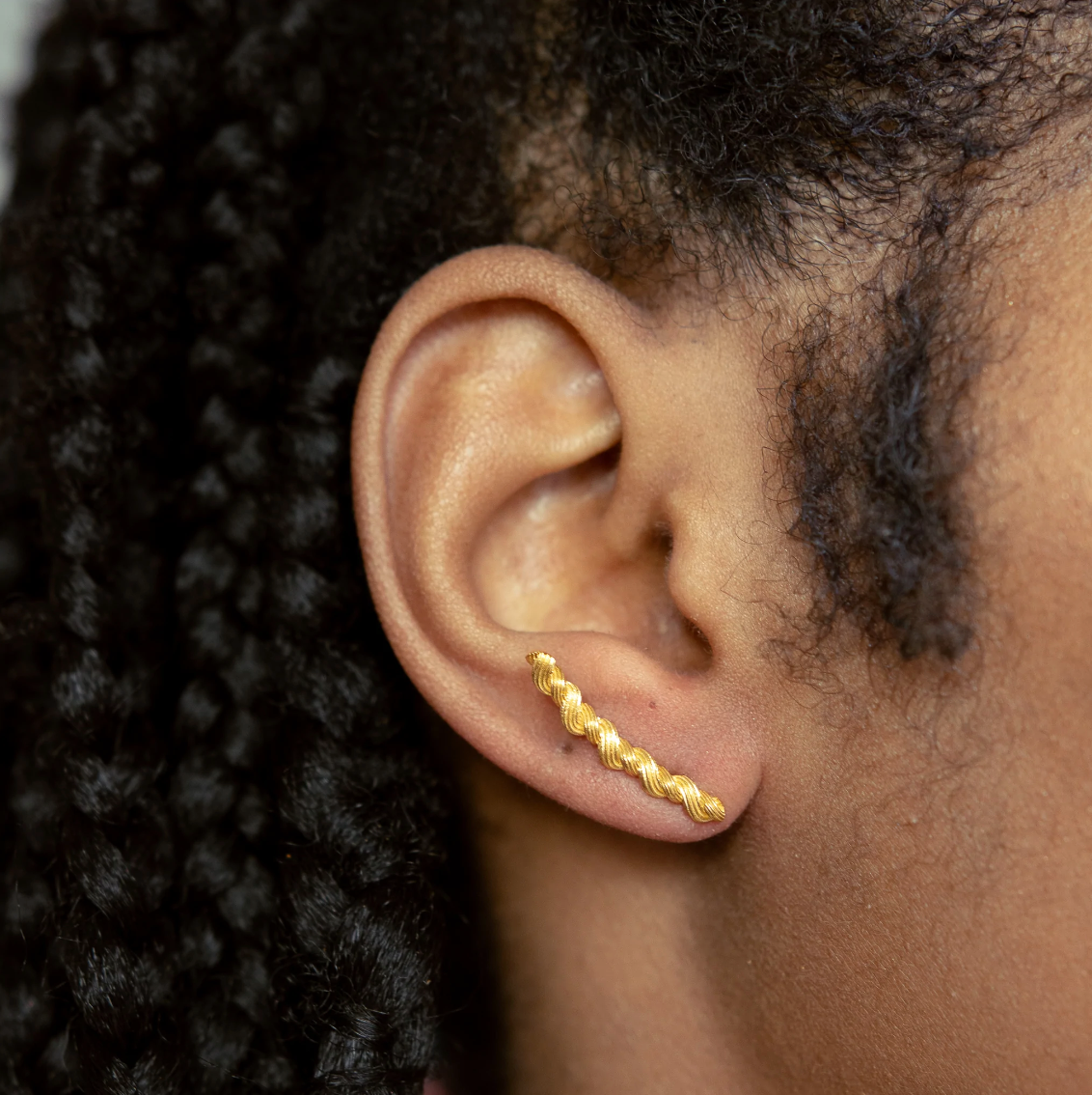 Load image into Gallery viewer, close up of model wearing the braided gold ear climbers
