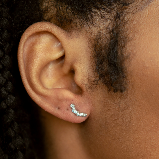 Load image into Gallery viewer, close up of model wearing the silver braided stud earrings
