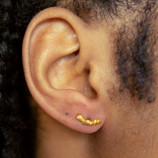 Load image into Gallery viewer, close up of model wearing the gold braided stud earrings
