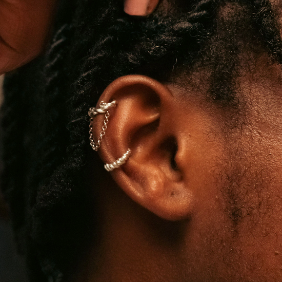 Load image into Gallery viewer, model wearing a silver braided roots cuff earring and a braided cuff earring
