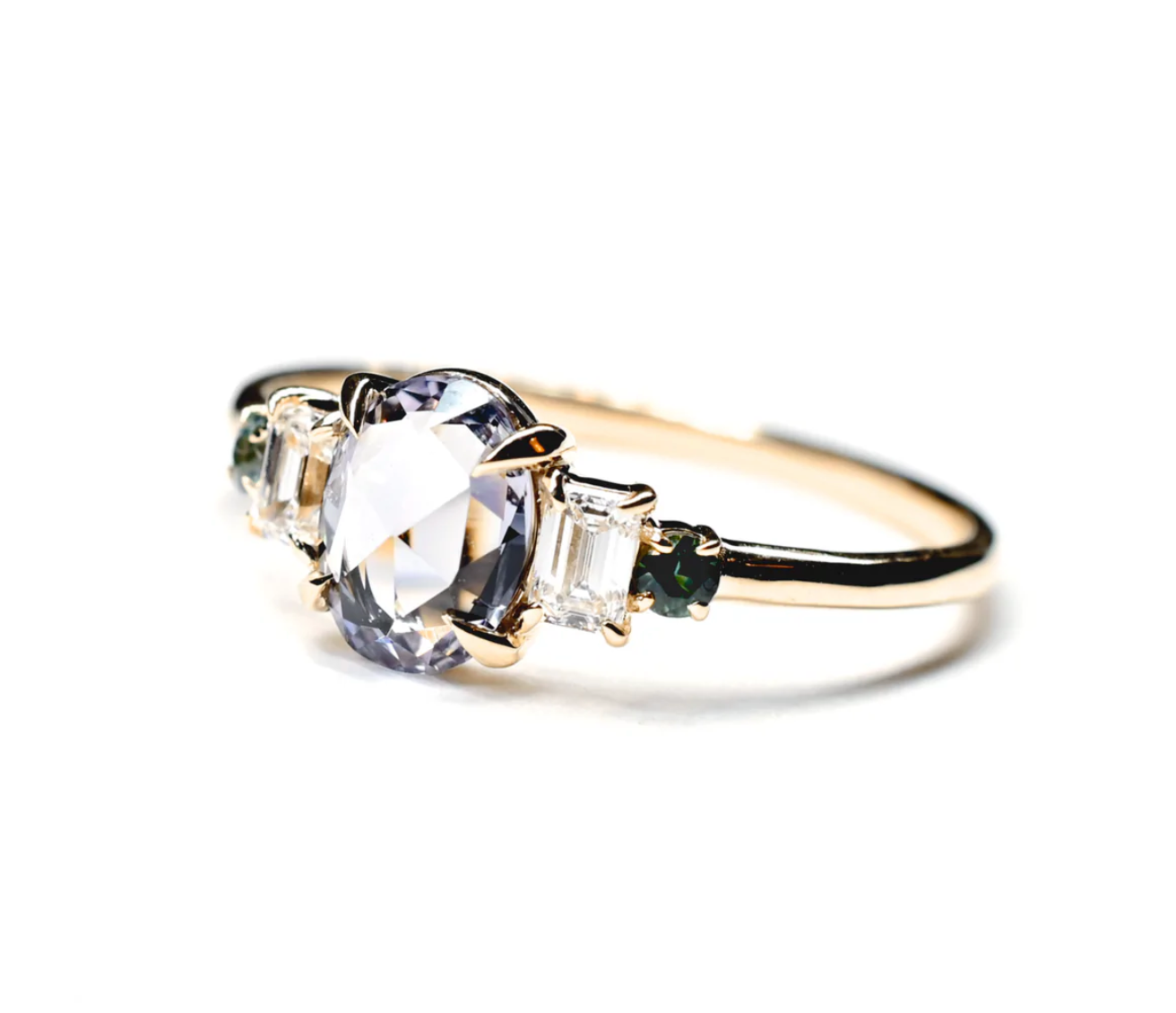 Load image into Gallery viewer, a yellow gold five stone ring featuring an oval spinel centerstone, two baguette white diamonds, and two round teal sapphires, sitting on a white background
