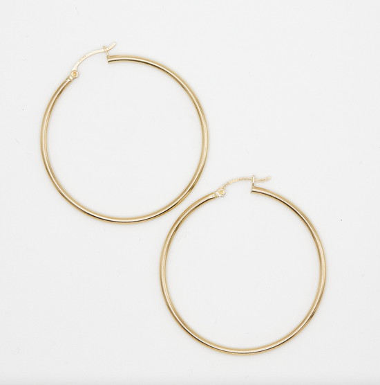 classic yellow gold hoop earrings on white background