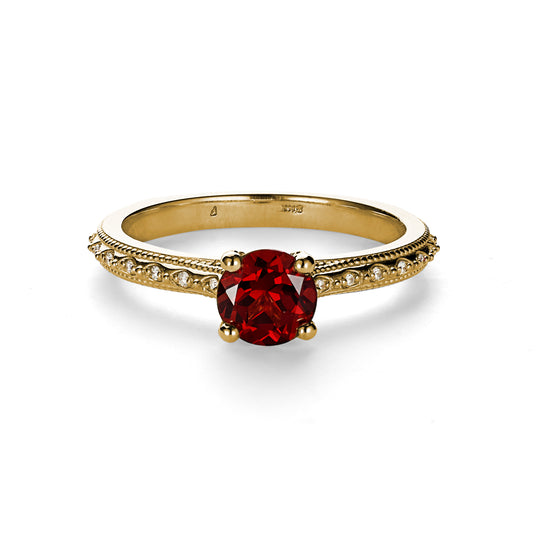 Victorian Mzxambique Garnet solitaire with diamond and milgrain detailed band on white background.