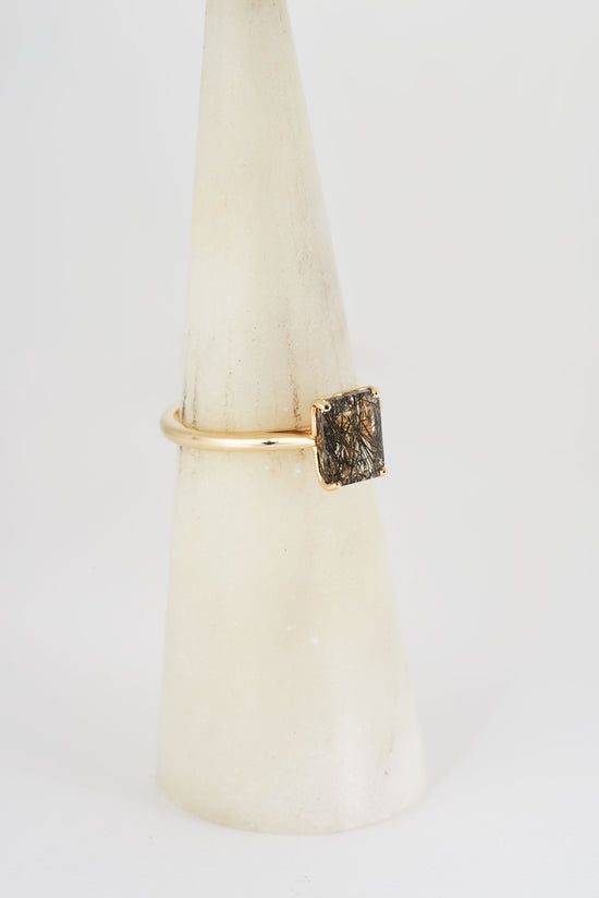 Side view of the Nico rutile quartz solitaire ring on a ring cone.