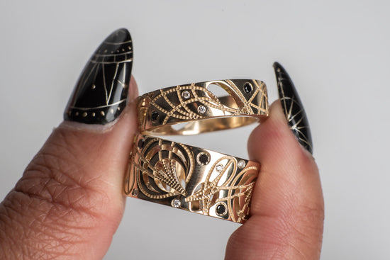 Load image into Gallery viewer, A model holding 2 yellow gold cigar bands with diamonds
