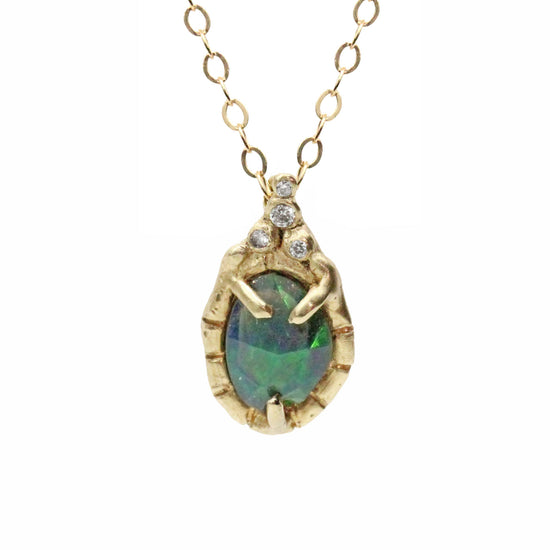 gold chain holding a green opal in 4 prongs, surrounded by free form diamonds pictured on white background 